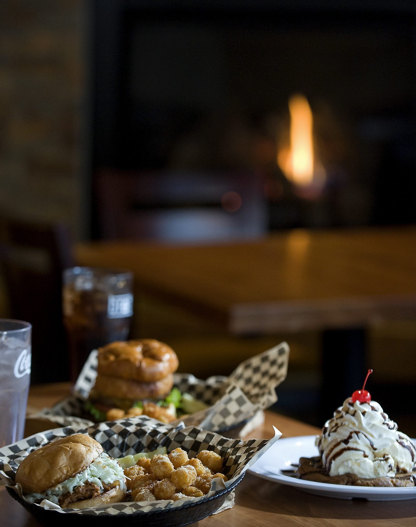 The Kahlua Pulled Pork sandwich goes well with Rosemary Parmesan tater tots, and the Hickory burger, background, is one of the most popular items on Brothers' menu. The Meltdown, a rich and filling dessert, is big enough to share.