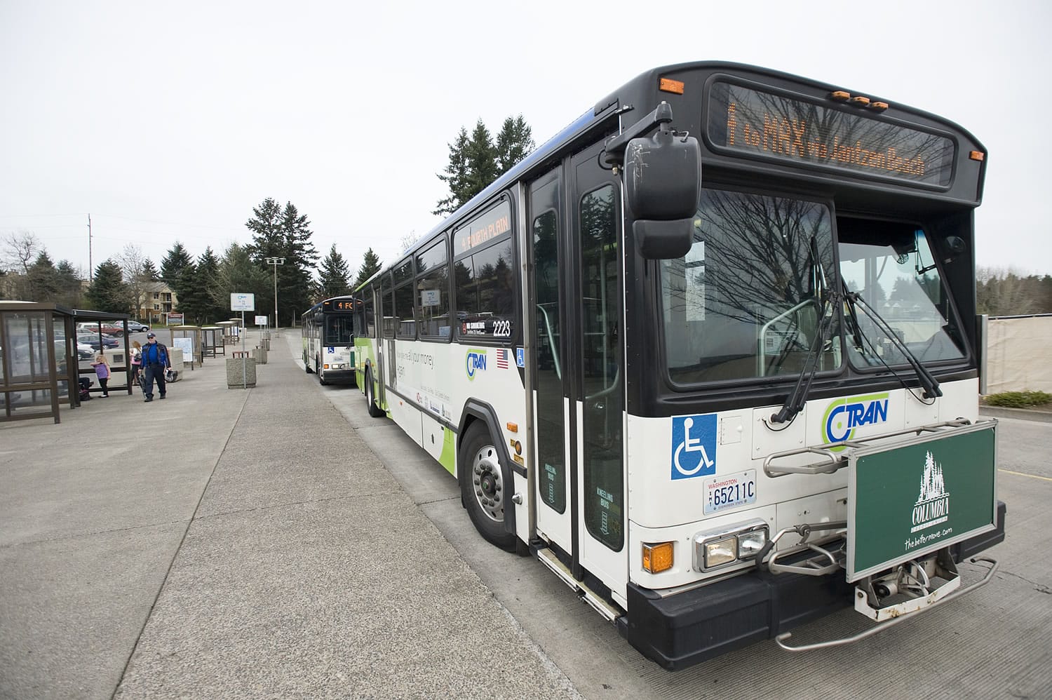 Passangers wait to board a C-Tran bus April 20 at the Vancouver Mall Transit Center.
