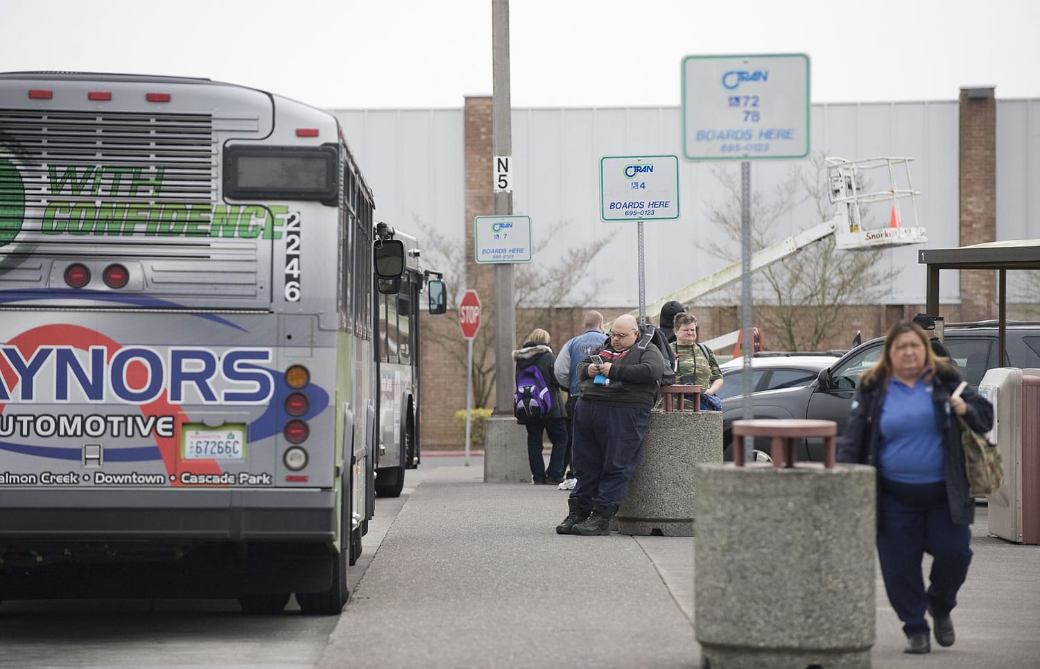 Passengers wait to board C-Tran buses at the Vancouver Mall Transit Center in April.