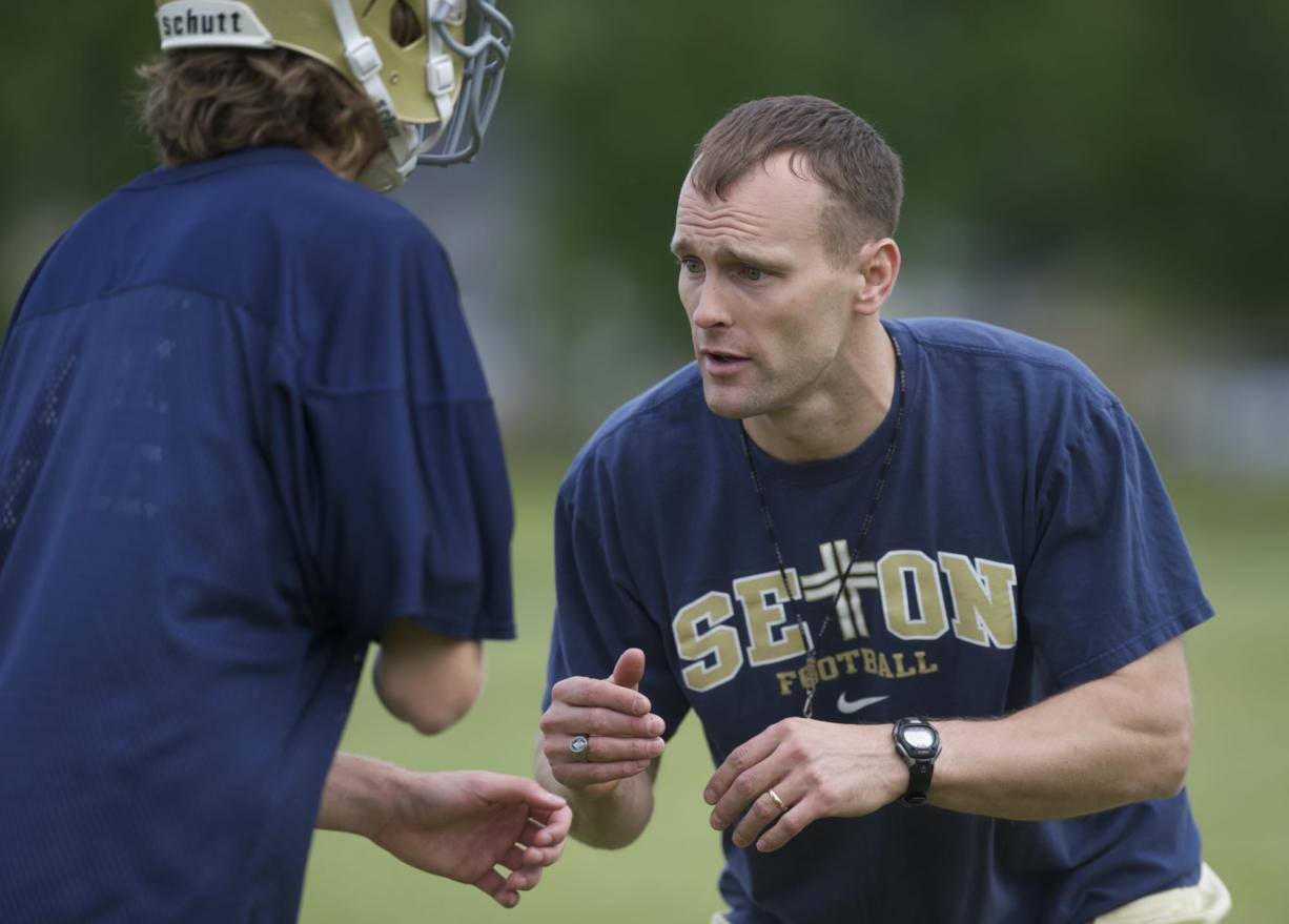 The Seton Catholic High School football Head Coach Dan Chase instructs his team during practice at Cascade Middle School on Thursday May 31, 2012.
