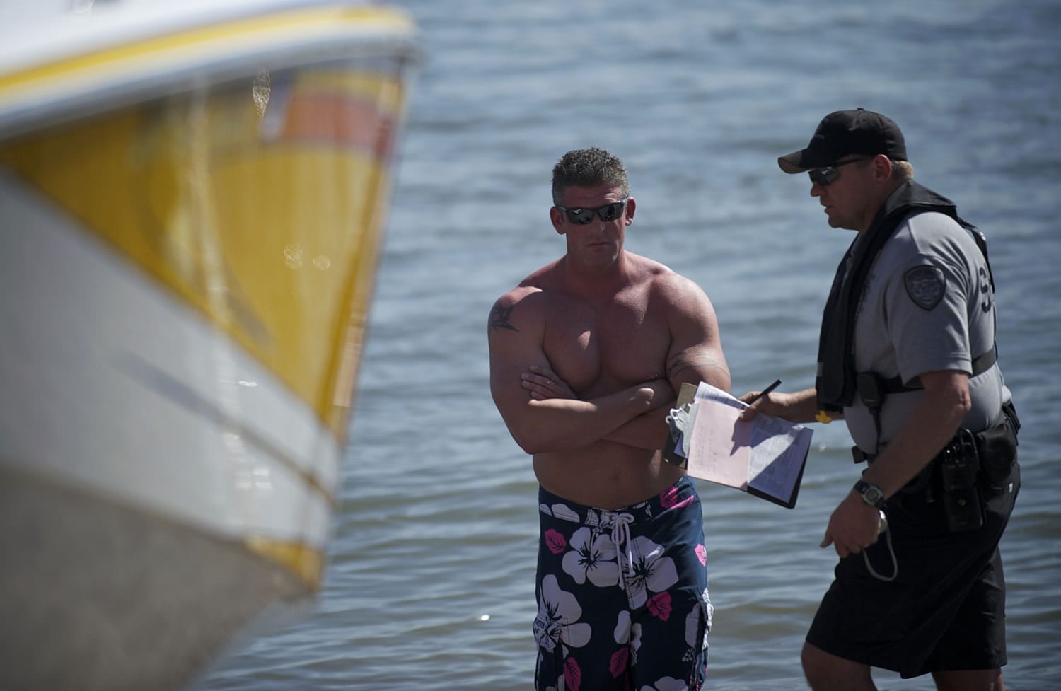 A police officer talks to the operator of a boat during the investigation of a boating accident at Wintler Park on Saturday.