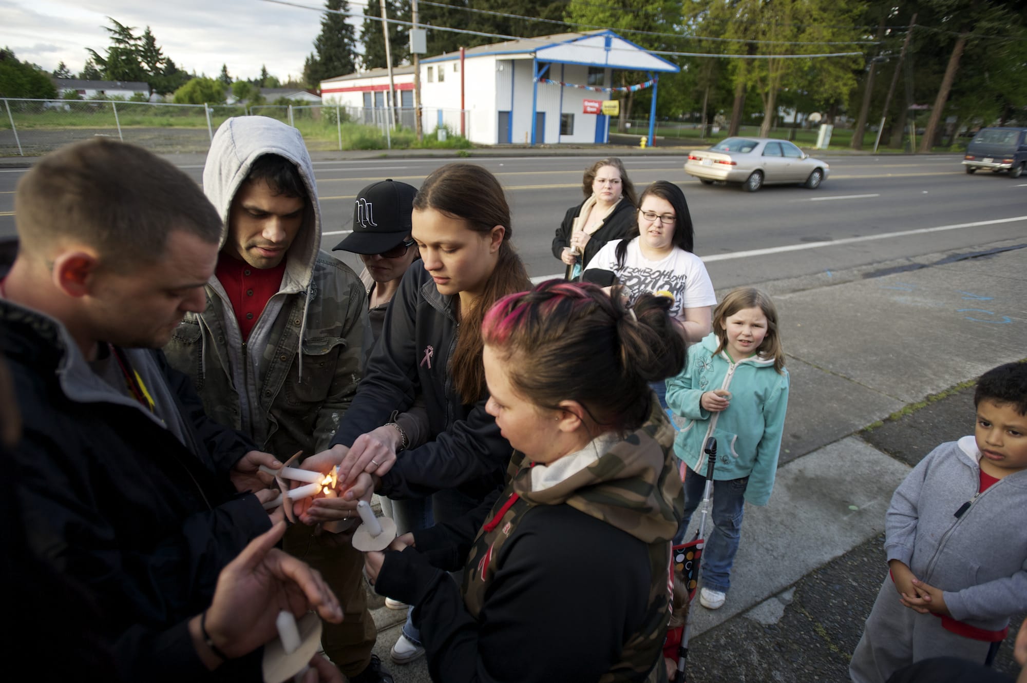 Steven Lane/The Columbian
Neighbors who witnessed the hit-and-run that killed  Maria Delos-Carrasco Angulo light candles in her memory Friday night in Vancouver. Angulo died Thursday night after being struck by a car as she crossed Fourth Plain Boulevard in a crosswalk.