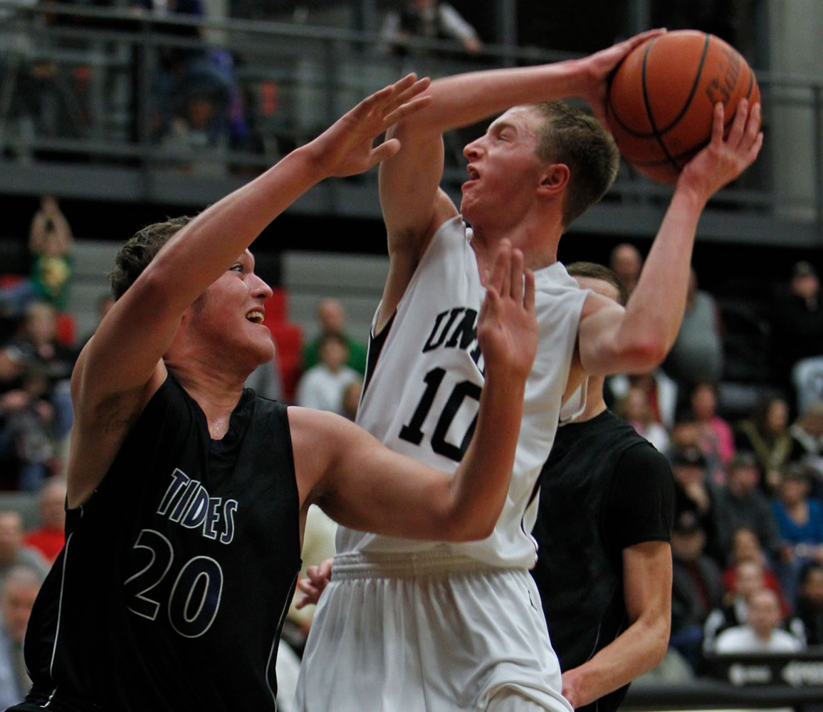 Union guard Tyler Copp (10) works inside against Gig Harbor guard Jared Murphy (20) in opening round of bi-district boys basketball tournament.