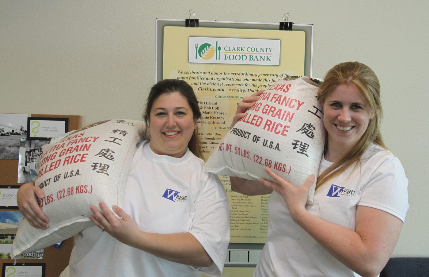 Esther Short: From left, Erin Wright, founder of the Wright Law Firm, and Courtney Claybin, paralegal, hold 50-pound bags of rice that the law firm donated to the Clark County Food Bank.