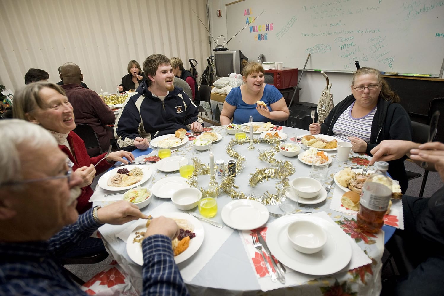 Winter Hospitality Overflow volunteers Dennis and Diane Smith, from left, share Christmas dinner with recipients Brandon Pesterfield, Brittany Meeker and Cheryl Harvey at St.
