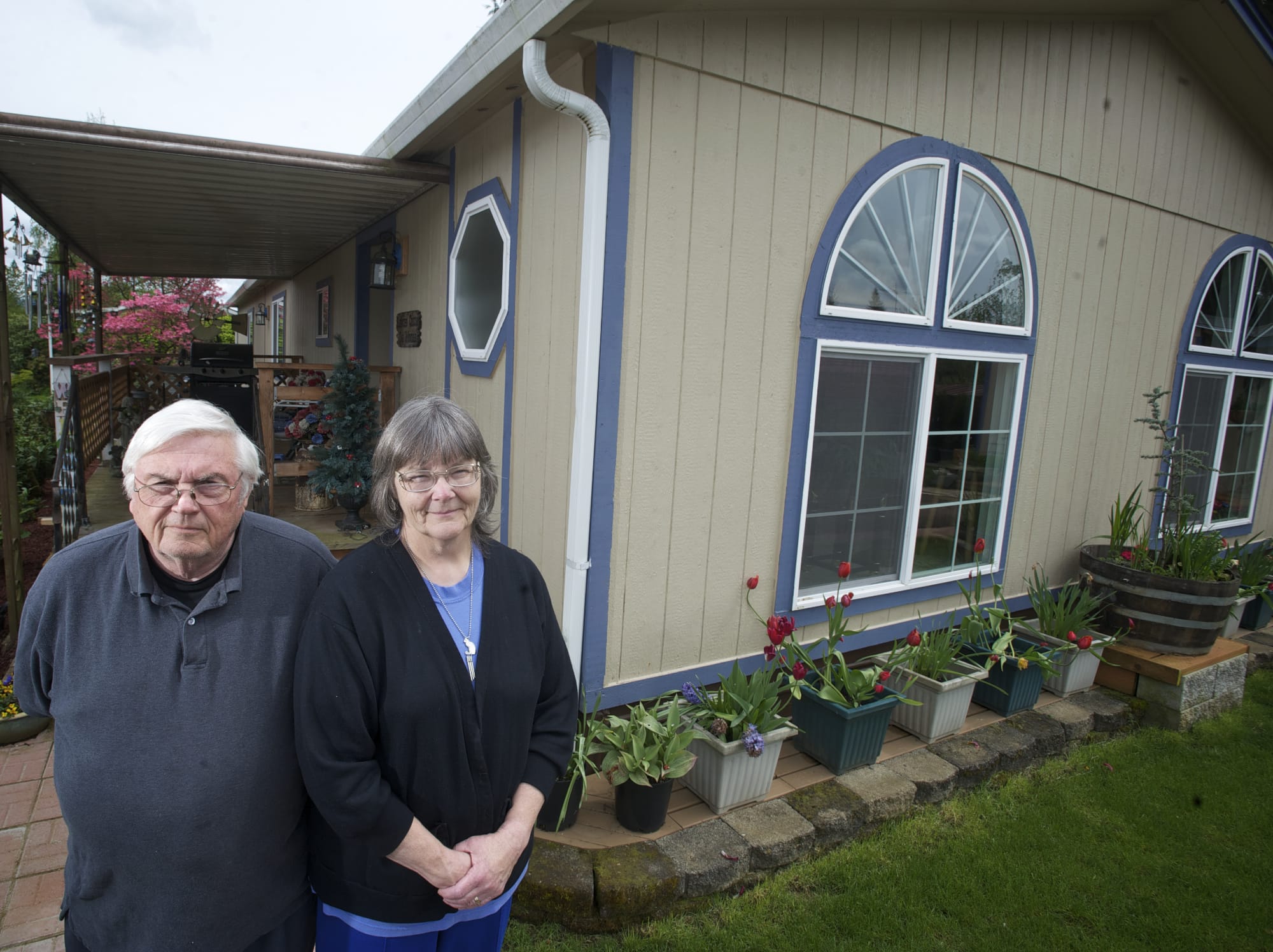Earl and Clydene Gere, who recently lost an appeal of their property value to the Board of Equalization, stand in front of their partially rebuilt Brush Prairie mobile home.