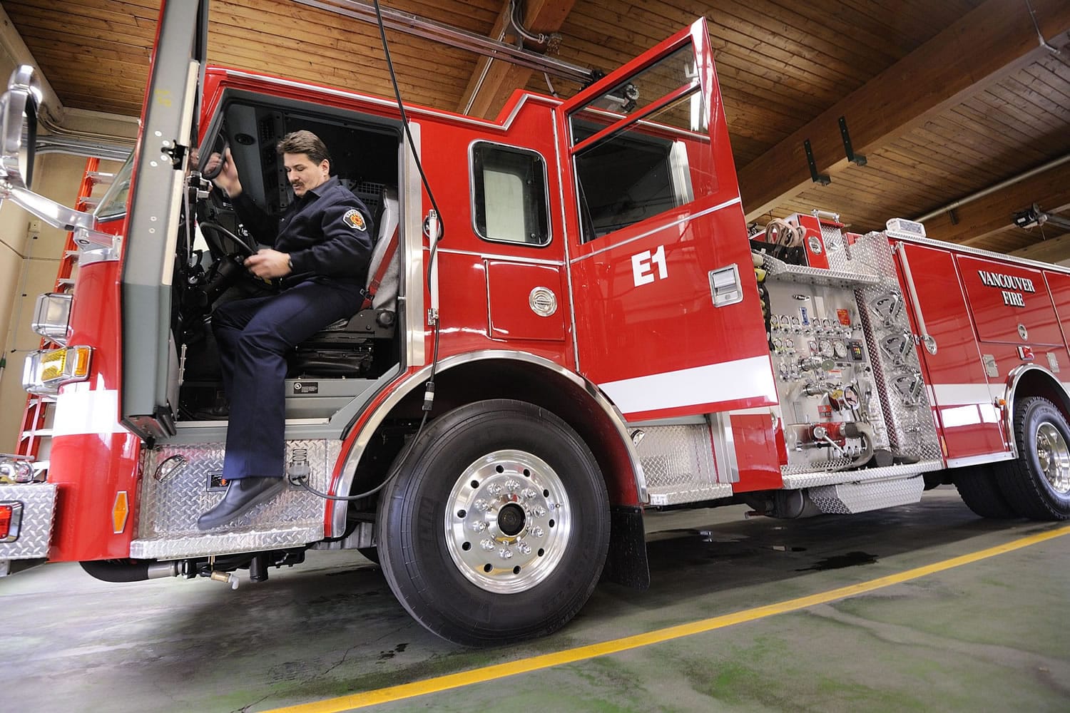 Dan Pearce, captain at Vancouver Fire Station 1, climbs out of his station's new engine on Tuesday.