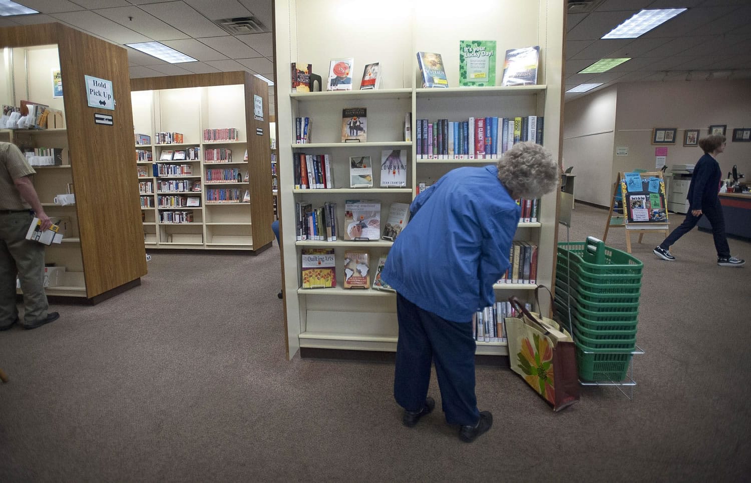 Dolly Jendro, of Washougal, looks over the new book selections Tuesday at the Vancouver Mall Community Library. The Fort Vancouver Regional Library District will reduce the space and services at the mall branch in 2013. &quot;It will have serious repercussions,&quot; Jendro, 81, said.