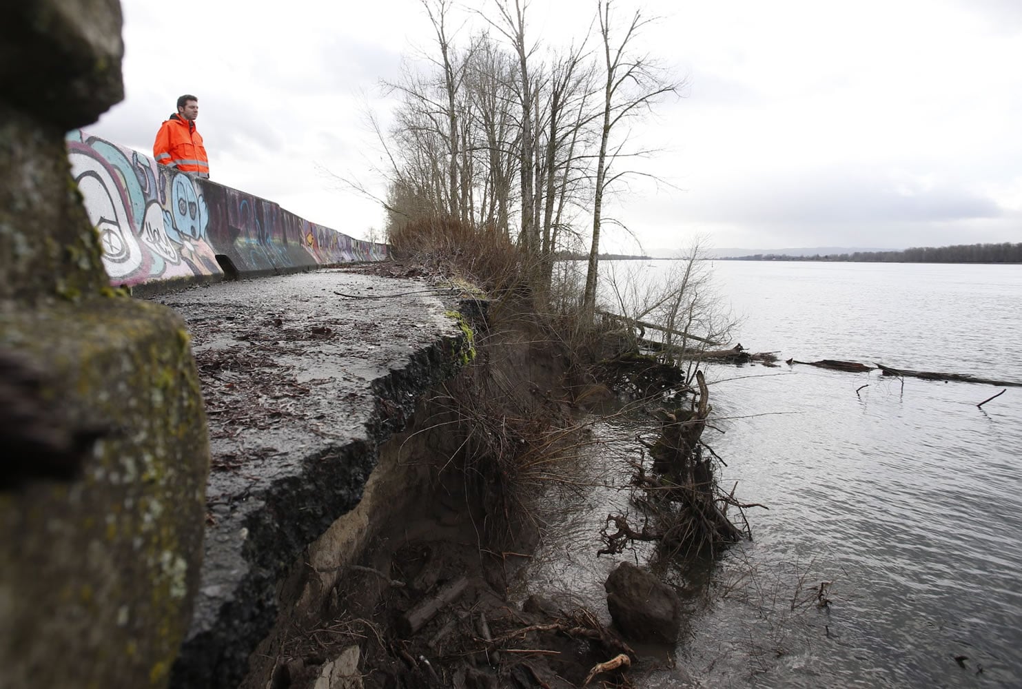 WSDOT spokesman Bart Treece stands  near a portion of Lower River Road that has been eroded by the Columbia River. After gating the road a little past Milepost 10 west of Frenchman&#039;s Bar in Vancouver last summer, WSDOT plans to transfer it to Clark County.