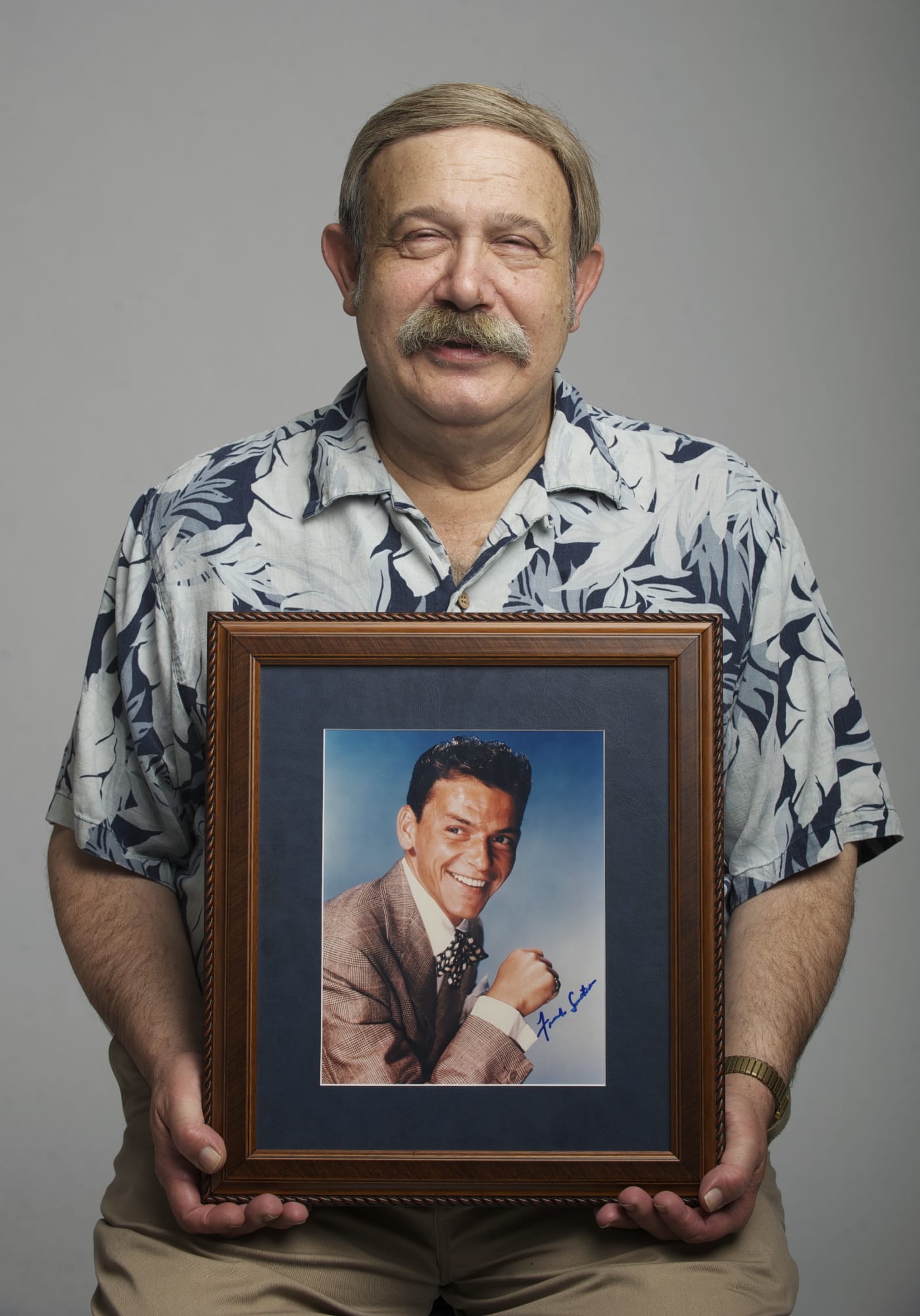 Collector Ron Zollo holds an autographed portrait of Frank Sinatra.