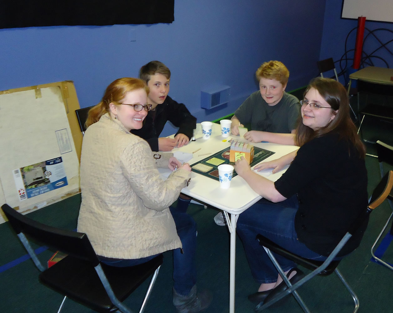 Bella Vista: Erin, James, and Maggie Altenhof-Long and Spencer Warner play board games.