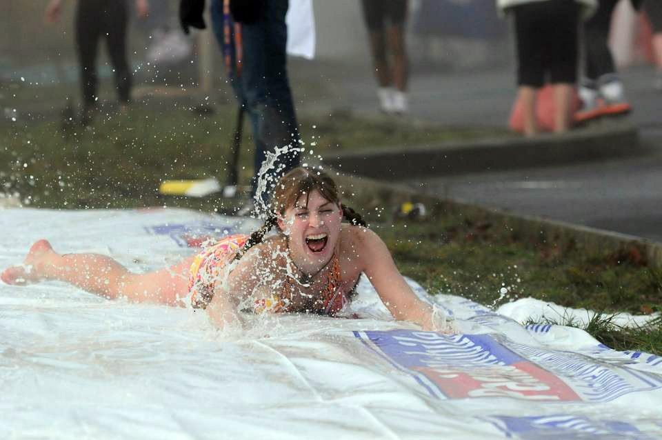 Battle Ground: Heather Hash of Vancouver participates in the Polar Bear Slide at the Resolution Run in Battle Ground.