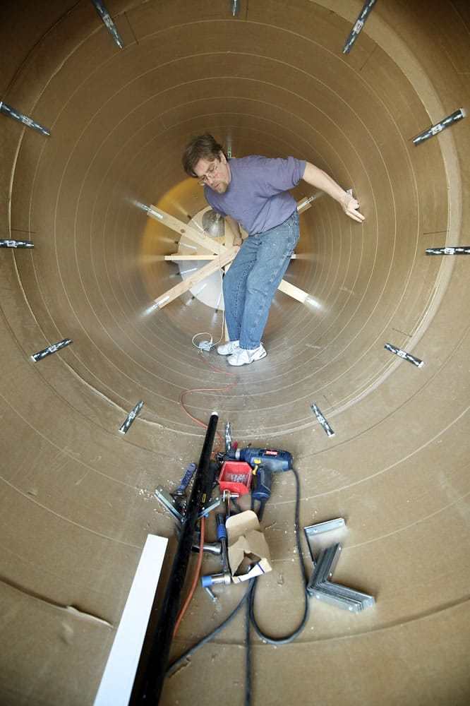 Robert Willard, a model-maker at Masterpiece Models, works inside a cardboard sonotube Wednesday.