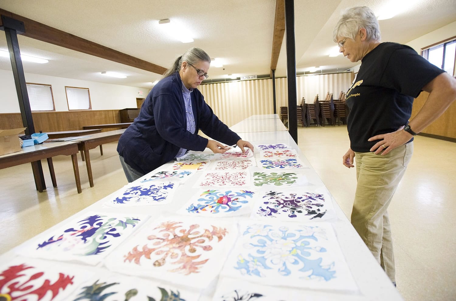 Mary Myers, 62, from Camas, left, and Toni Kapitanovich, 65, from Battle Ground, plan a quilting project at the Washington Grange No.