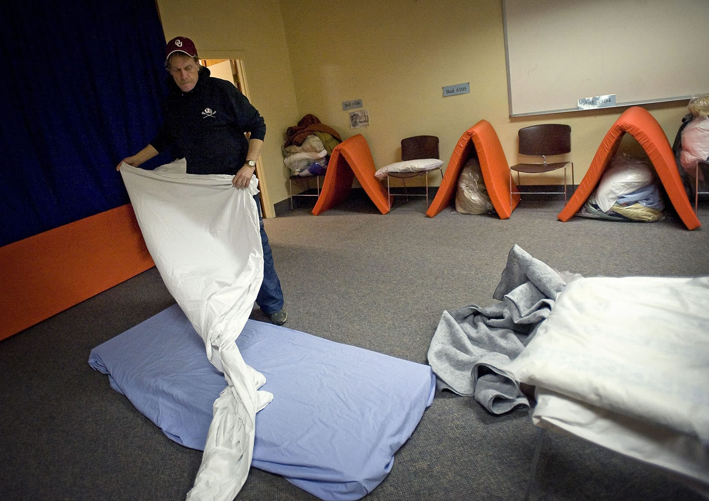 Mark Bailey, 53, gets his bed ready for the night at the Winter Hospitality Overflow shelter at St. Paul Lutheran Church in Vancouver, which houses 24 men a night.