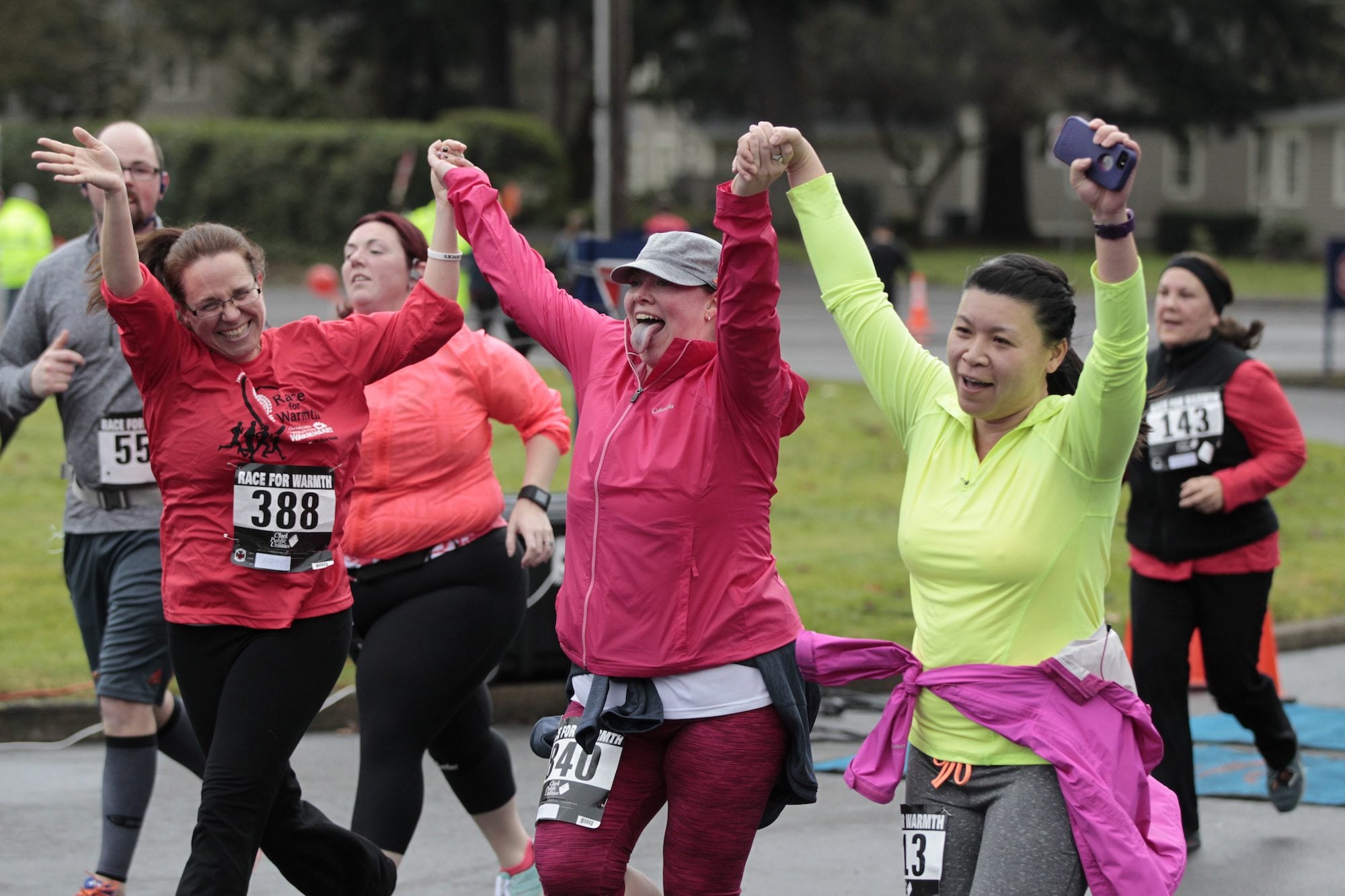 Heather Luarca, from left, Summer Murphy and Karen Chan finish the 5K run Sunday during the Race for Warmth in Vancouver. Proceeds from race registration will go to Clark Public Utilities&#039; Operation Warm Heart program, which helps customers in need pay their power bills.
