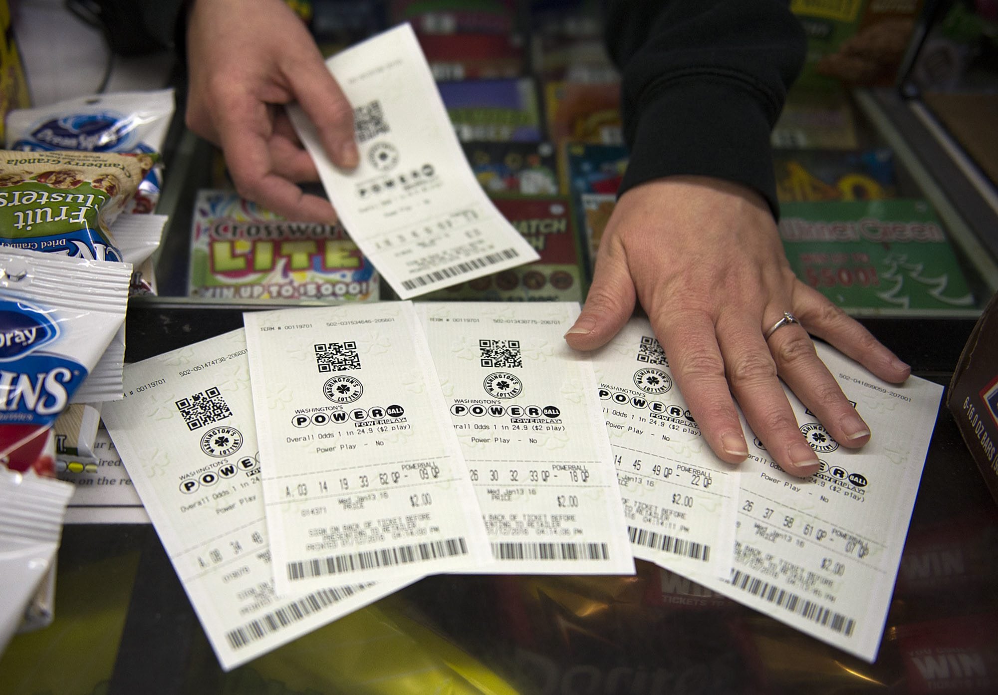 A customer purchases Powerball tickets at Plaid Pantry on Kaufmann Avenue Tuesday evening.