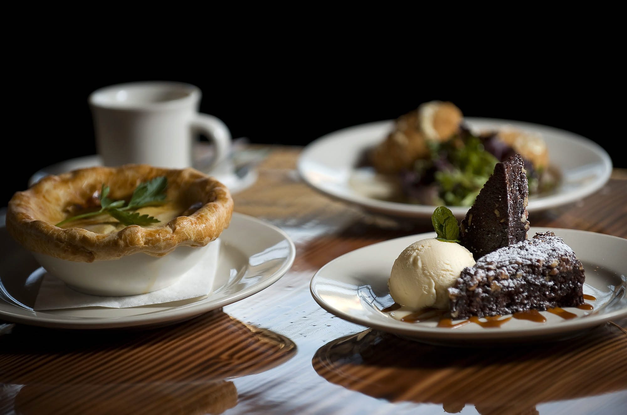 The Pecan Praline Brownie, clockwise from right, Chicken Pot Pie and Crab Cakes are menu highlights at the Mill Creek Pub in Battle Ground.