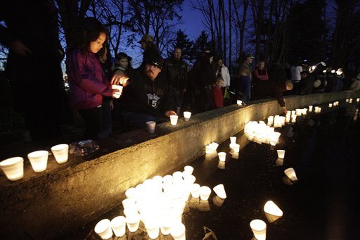 Mourners float candles at McKinley Park in Tacoma on Monday,during a candlelight vigil. The ceremony was held the day after Braden and Charlie Powell were killed along with their father, Josh Powell, when, according to police, Josh Powell set fire to the house they were in on Sunday.