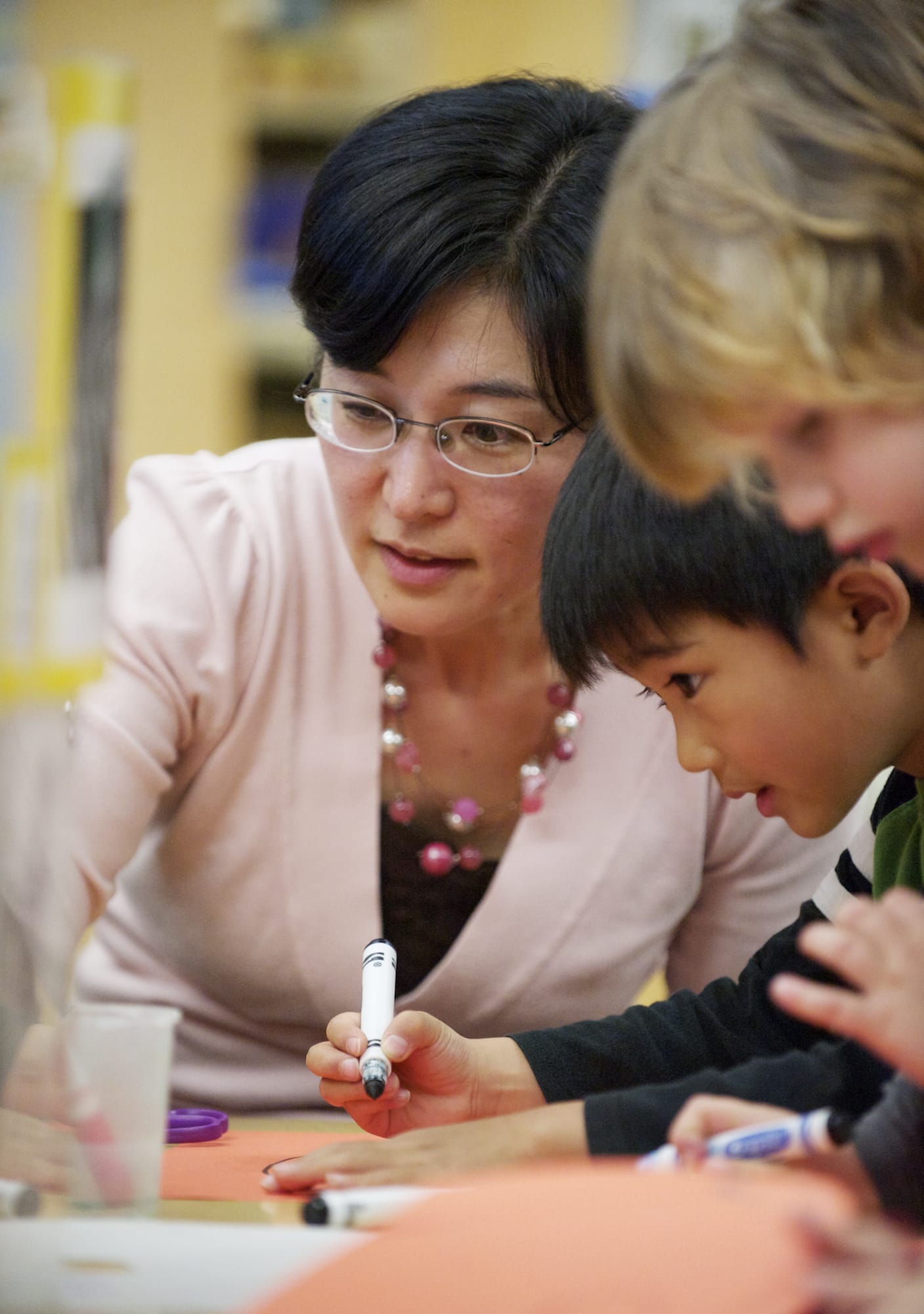 Yoshie Sano, assistant professor of human development at Washington State University Vancouver, watches her 5-year-old son, Reon Sano-Ochiai, draw a tiger at the WSUV Childhood Development Center.