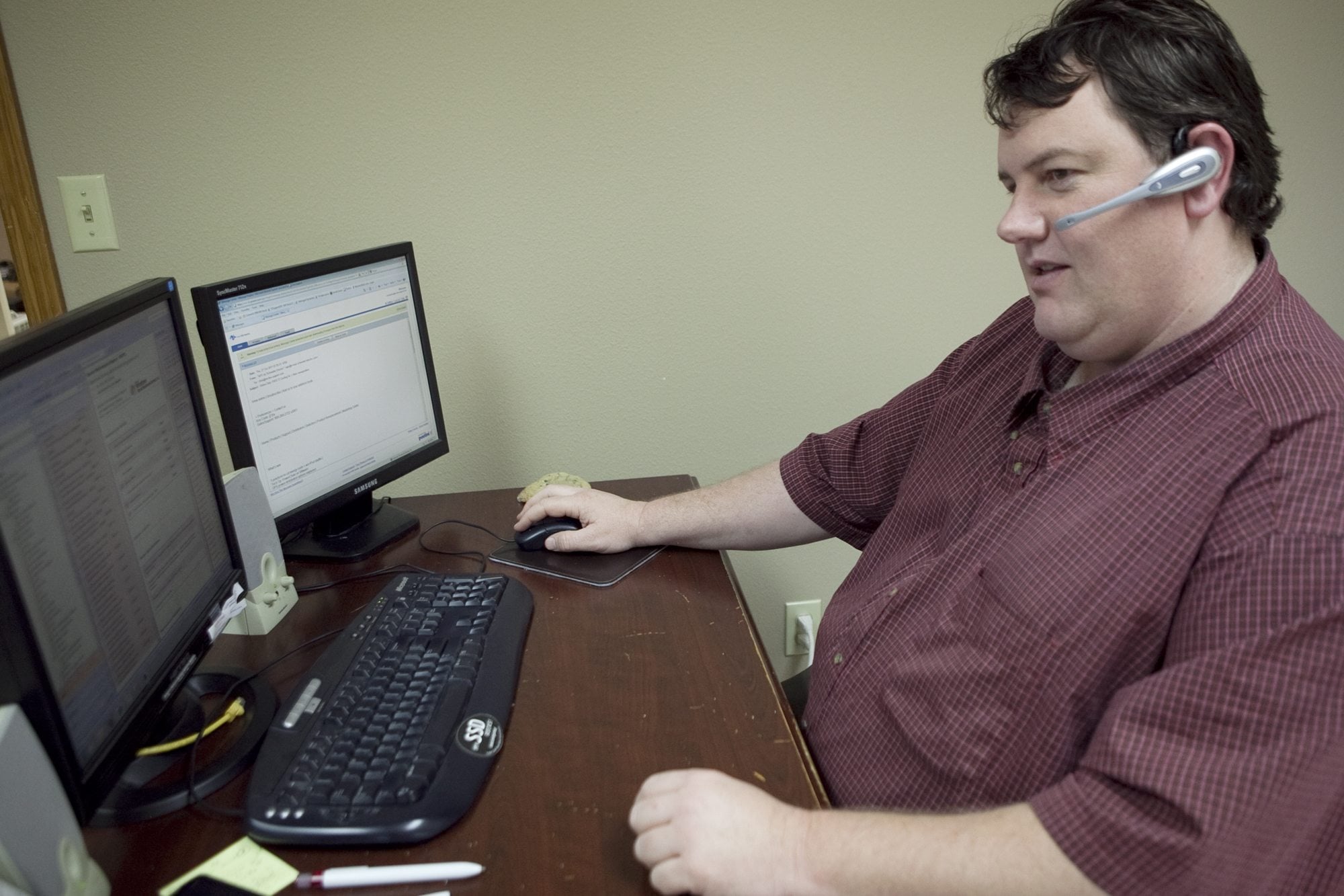 Christopher Kirk, a senior technology consultant, takes calls and answers customer questions.