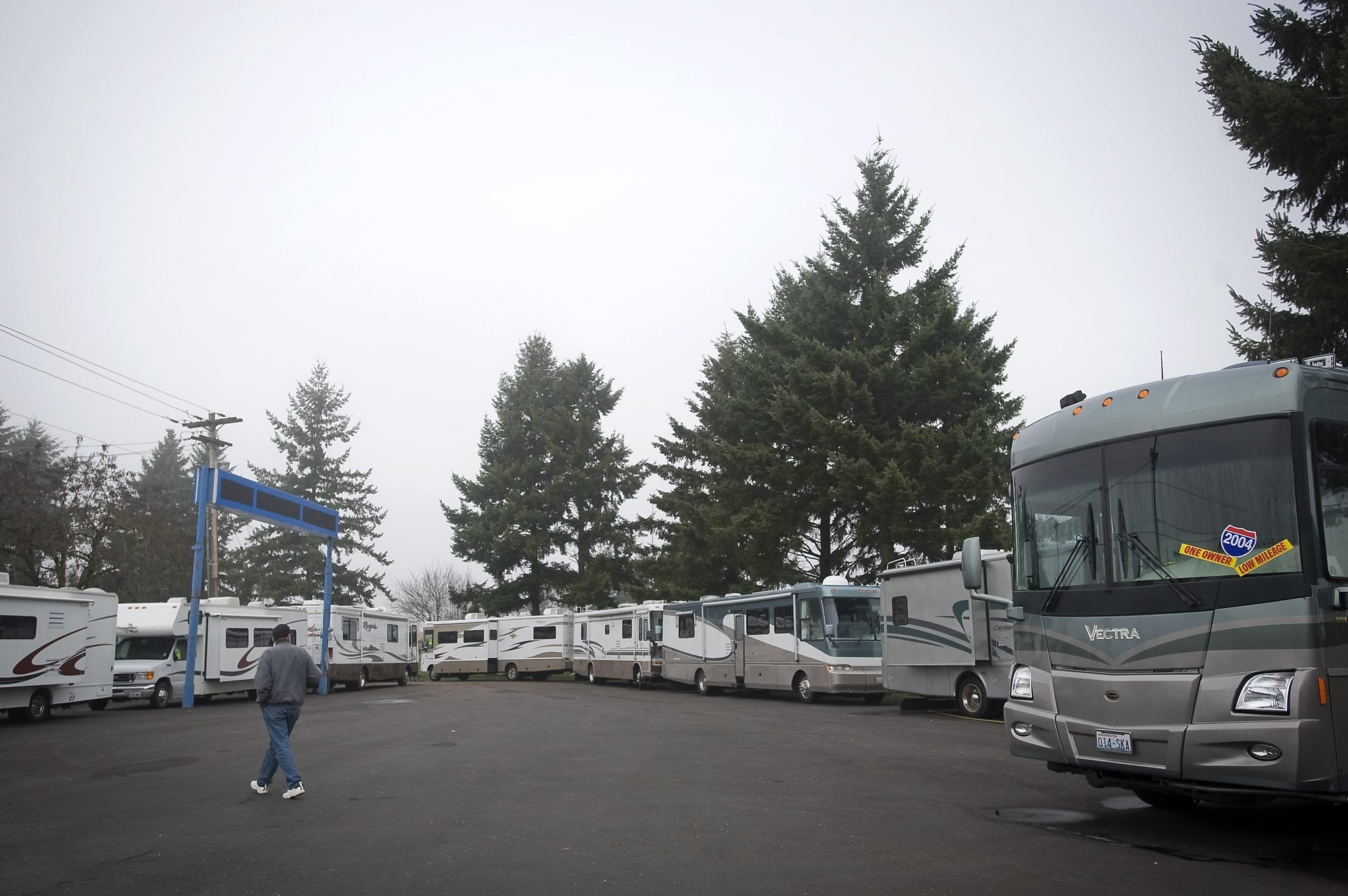 An employee of Bentley RV crosses the dealership's new location on a portion of the former Curt Warner Chevrolet site off Interstate 205 and Southeast Mill Plain Boulevard.(Zachary Kaufman/The Columbian)