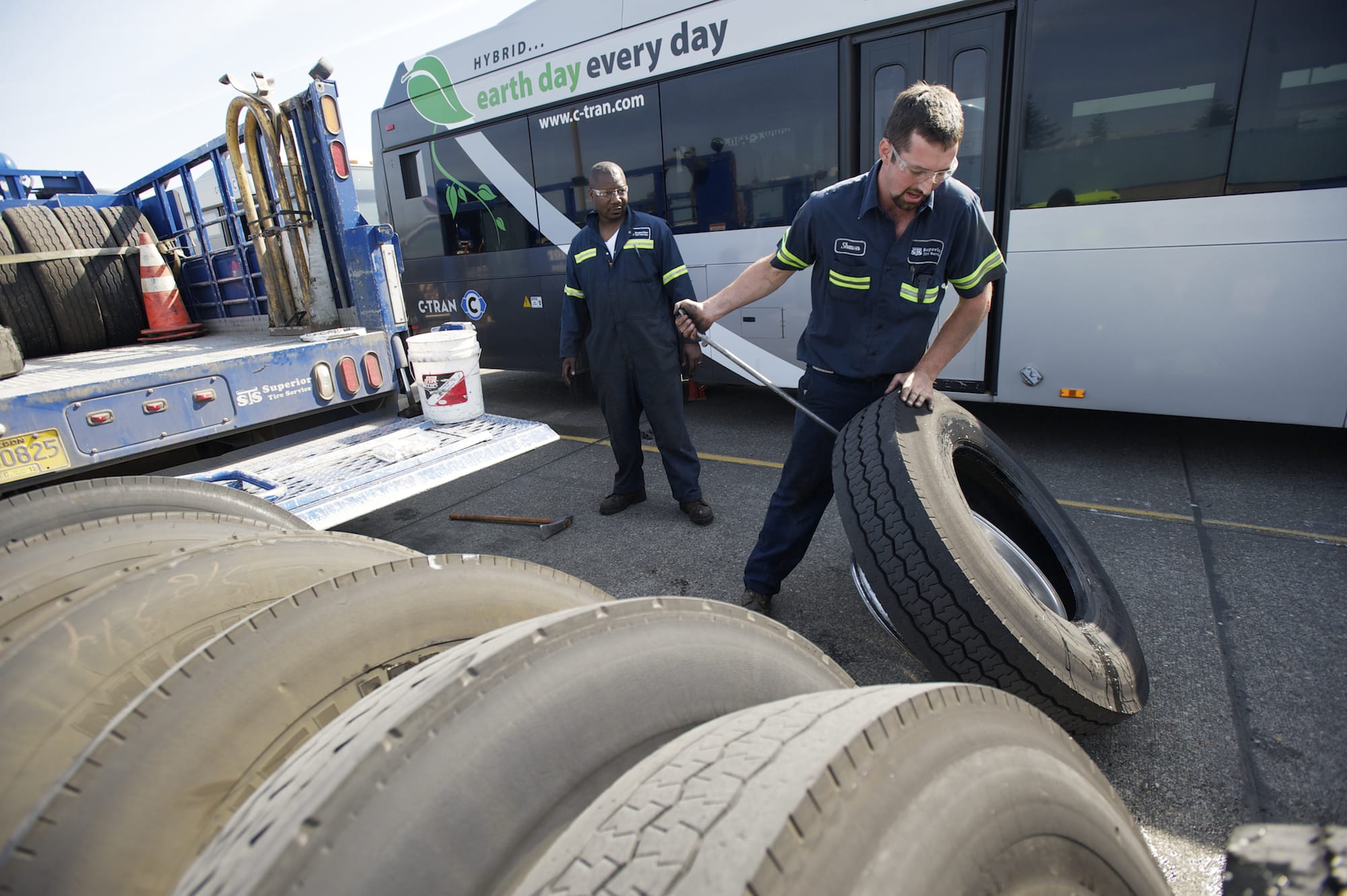 Photos by Steven Lane/The Columbian
Superior Tire Service workers Shawn Paulus, right, and Kapaya Goodson replace faulty tires on a C-Tran bus this week. The agency raced to replace hundreds of tires recently recalled by Michelin.