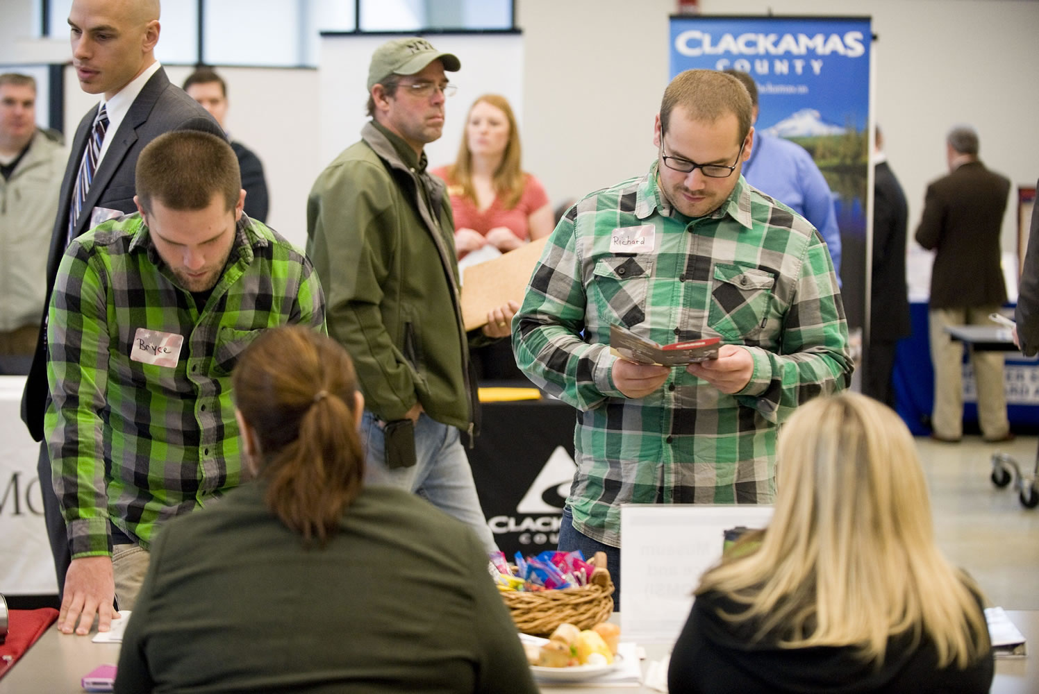 Army veterans Bryce Sanman, 24, left, and Richard Sheldon, 23, talk about job opportunities at OMSI at Thursday's job fair. Sanman and Sheldon served in Iraq together.