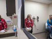 Photos by Zachary Kaufman/The Columbian
Medical assistant Lisa Wood, left, takes information from patient Barbara Kelly of Vancouver during a routine follow-up visit to Columbia River Occupational Health.