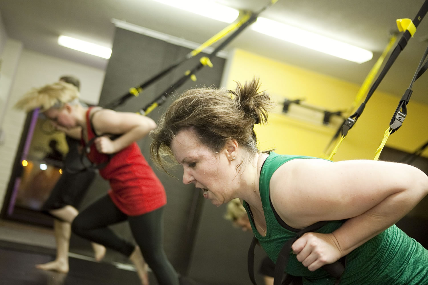 Janelle Hoyt, 47, works up a sweat during the TRX Suspension Training class at Flores Fitness.