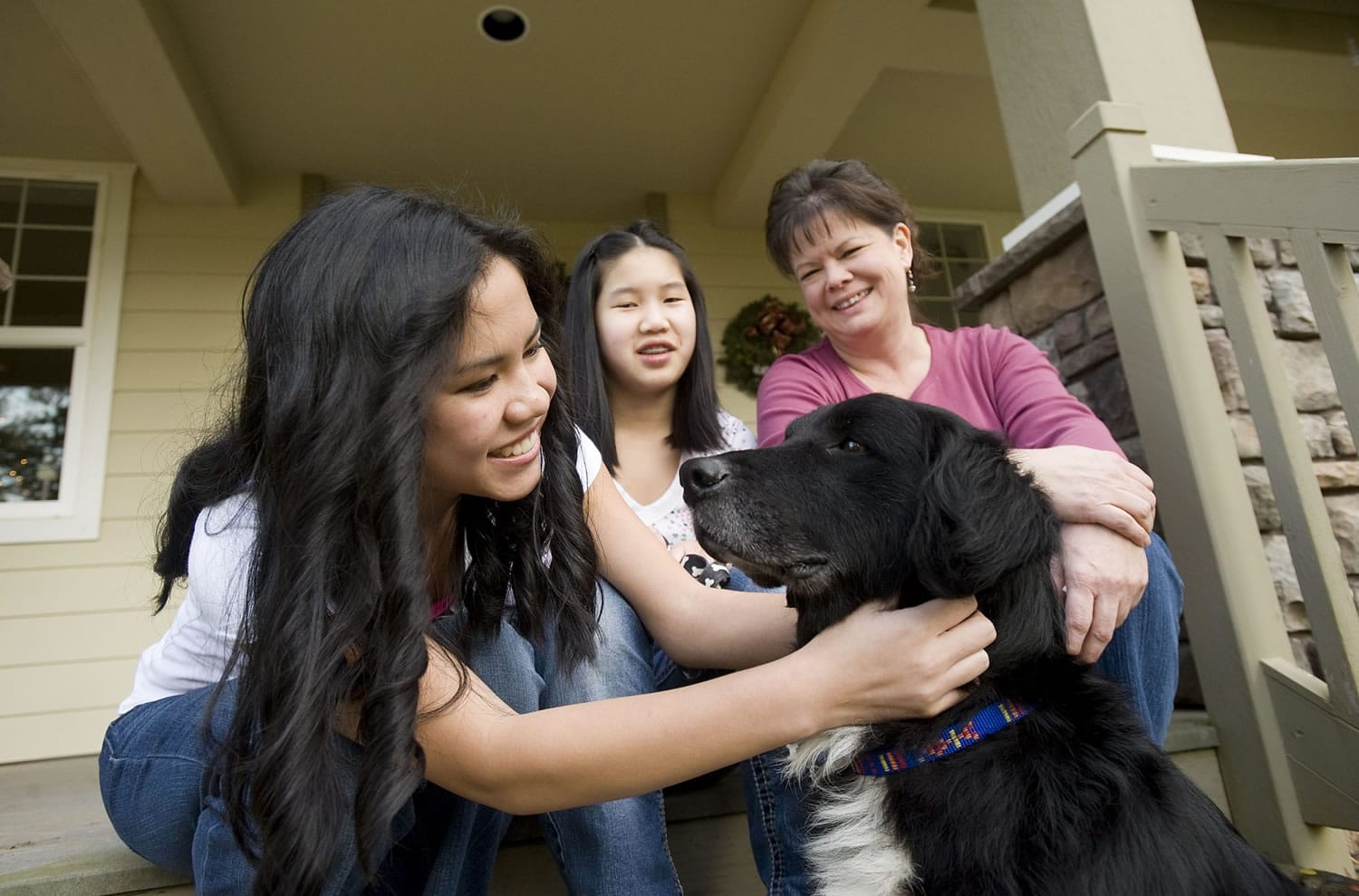 The Hickey family, from left, Sydney, 16, Olivia, 14, and Belinda, recently adopted Bella, a border collie mix that belonged to Steven Stanbary, who killed his wife and twin sister and then set fire to the house they shared in Washougal. Stanbary also died. Bella and two other dogs and a cat survived the fire and shootings.
