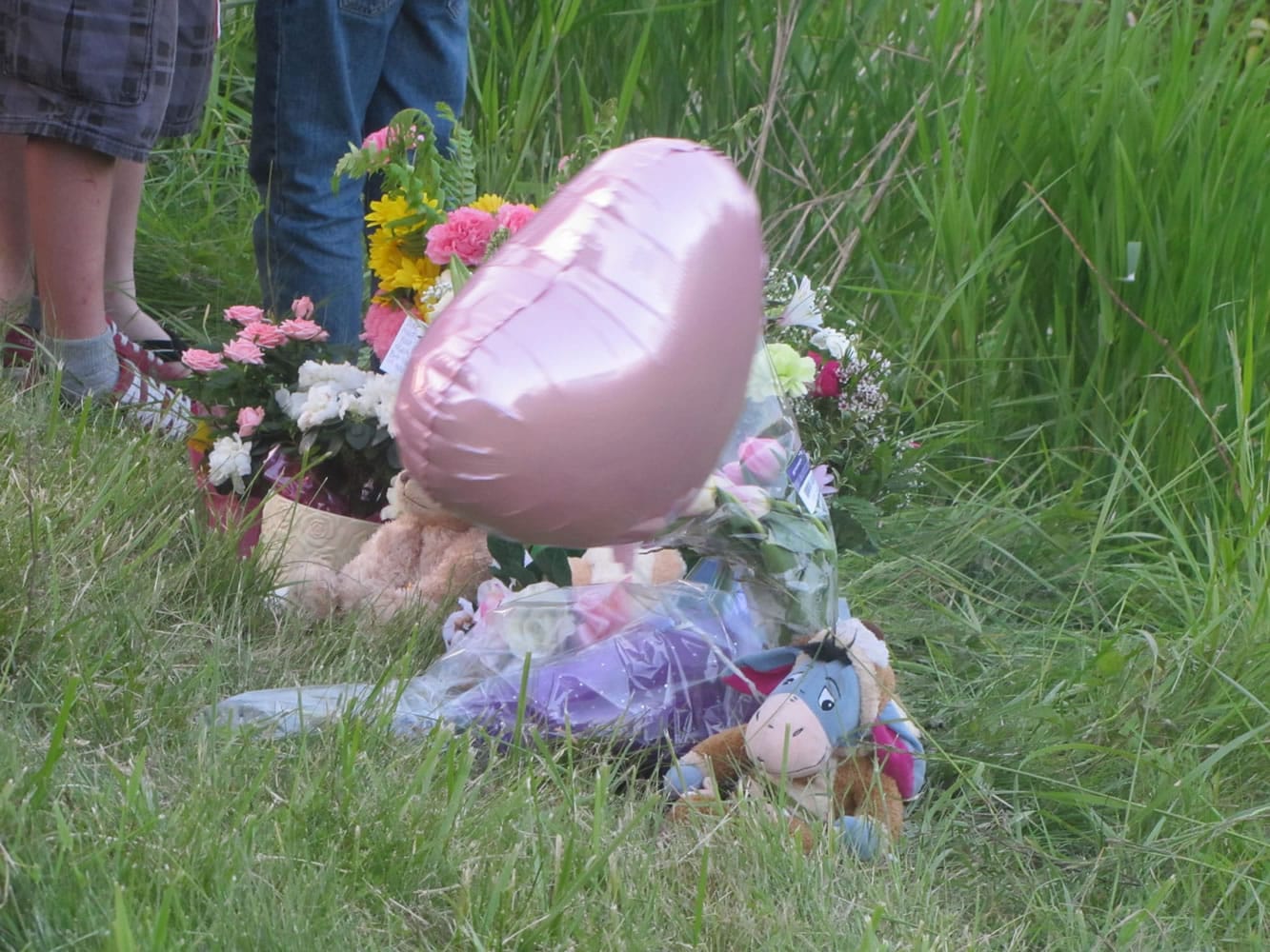 Mourners placed flowers, stuffed animals and a balloon Saturday night off S.W. 10th Avenue near the site where 22-year-old Tatyana Tupikova's body was found the previous day.