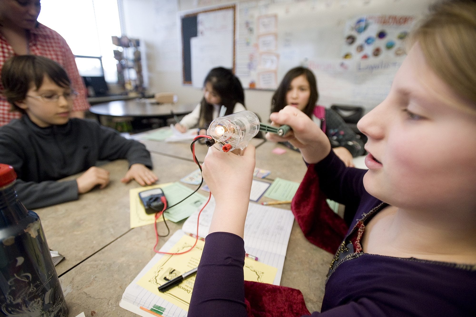 Hannah Callan, 10, a fifth-grader at Columbia Valley Elementary School, cranks her own electricity Tuesday.
