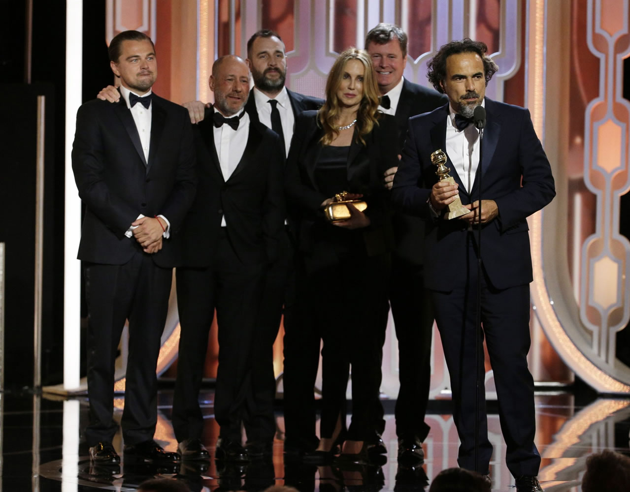 In this image released by NBC, Leonardo DiCaprio, left, looks on with the crew of "The Revenant," as director Alejandro G. Inarritu, right, accepts the award for best motion picture drama during the 73rd Annual Golden Globe Awards at the Beverly Hilton Hotel in Beverly Hills, Calif., on Sunday, Jan. 10, 2016.