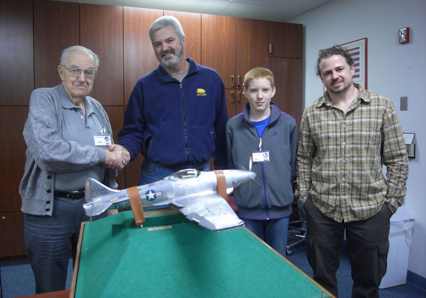 Hudson's Bay: Pearson Air Museum volunteer John Kalde, left, shakes hands with George Humphries, who loaned the museum a fighter plane model for the new Tuskegee Airmen display.