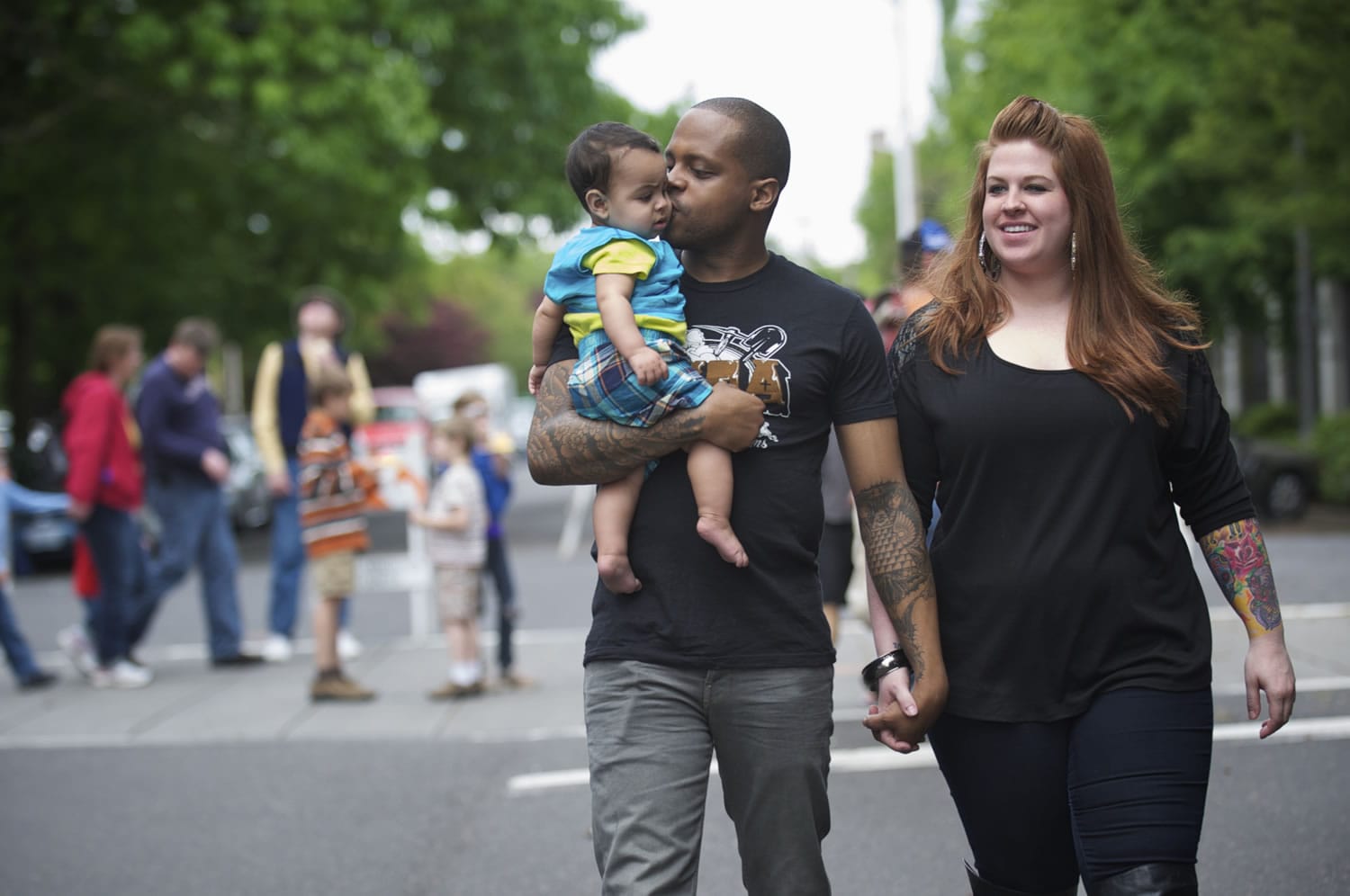 Randi King and her fiance, Cornell Collins, take a walk with their baby, Mason, 8 months.