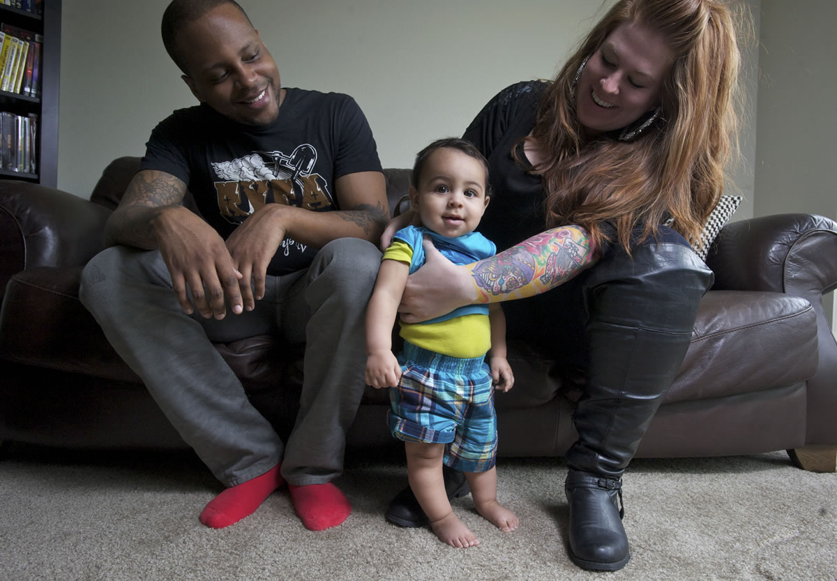 Randi King and her fiance, Cornell Collins, play with their baby, Mason, 8 months, at their downtown Vancouver home.