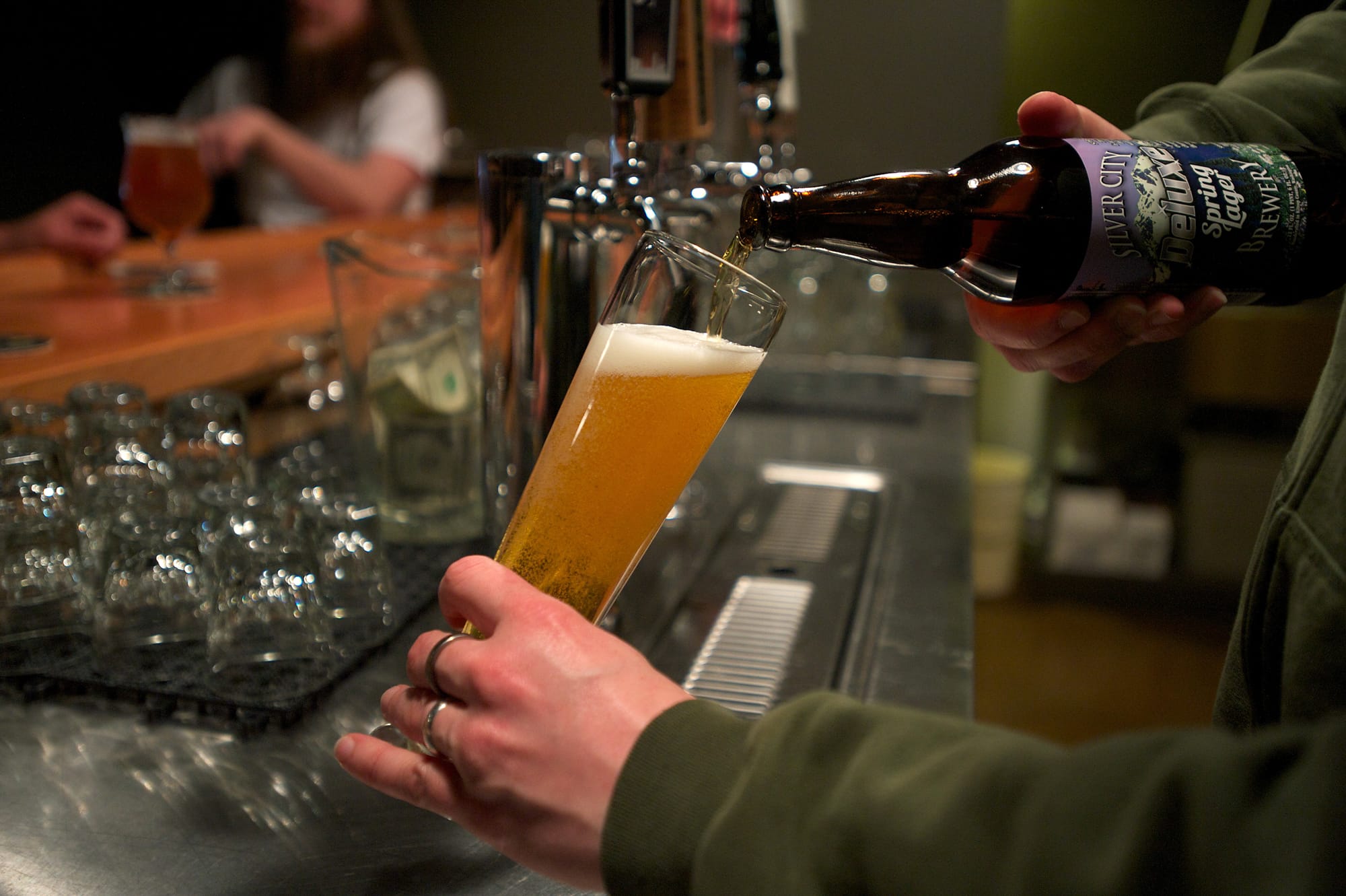 Angelo De Ieso II pours a bottle of Silver City Deluxe Spring Lager at By The Bottle's Taproom in downtown Vancouver.