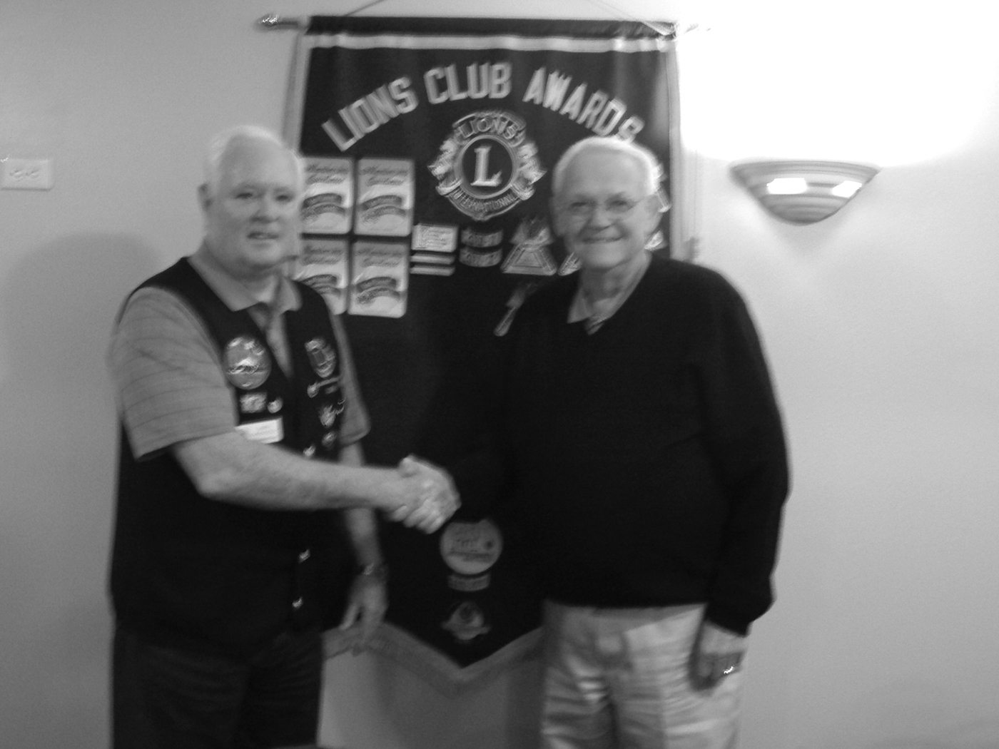 Hudson's Bay: John Donnelly, left, immediate past-president of the Vancouver Lions Club and volunteer project manager for the piano hospital's HVAC project, shakes hands with Terry Robertson, vice chair of the Northwest Lions Foundation.