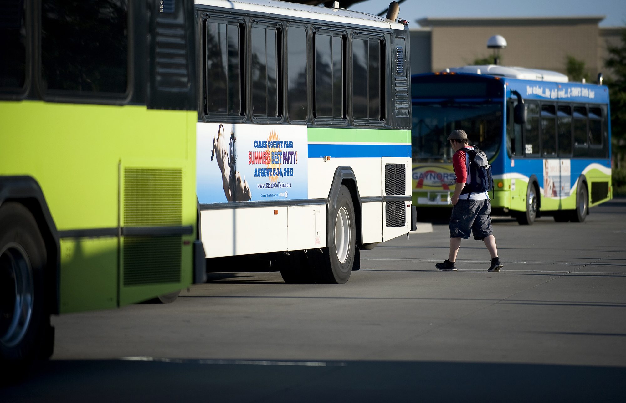 A passenger prepares to board a bus July 28 at the 99th Street Transit Center.