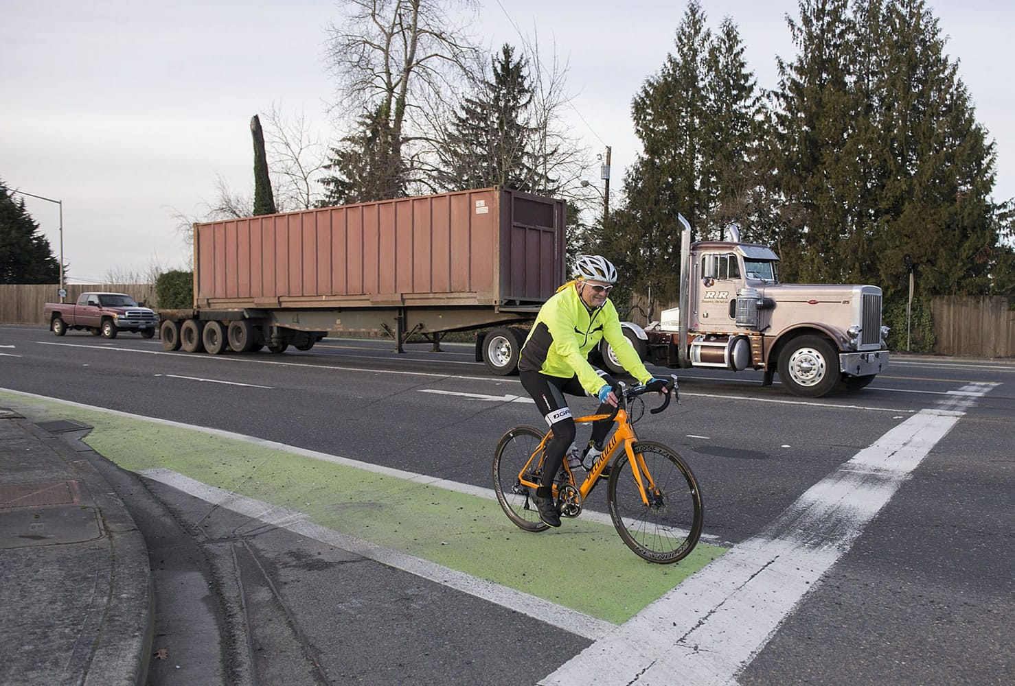 A cyclist traveling on state Highway 501 travels in a green bike lane near St. Francis Lane in Vancouver.
