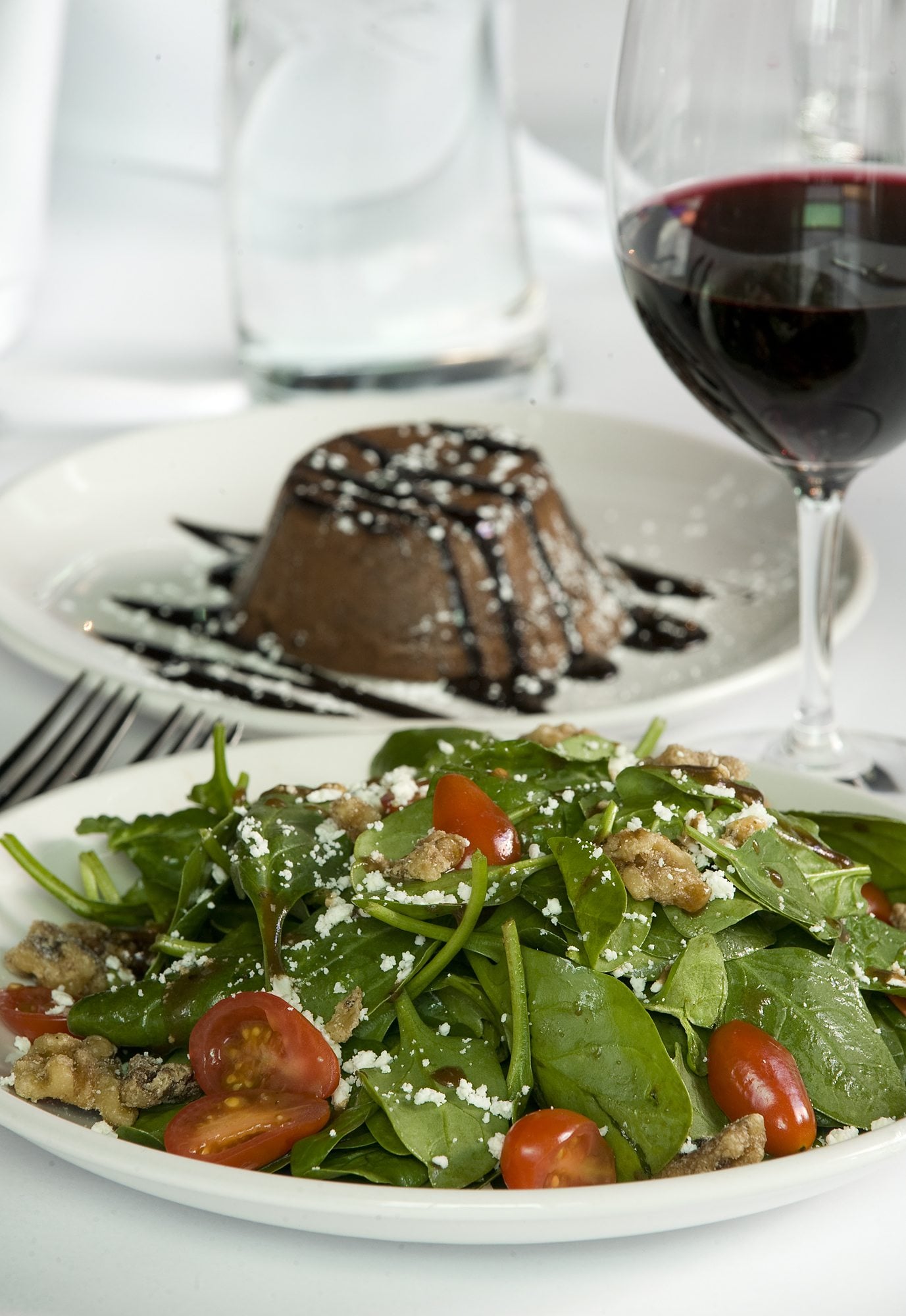 Spinach Salad with candied walnuts and goat cheese and Chocolate Lava cake are among the offerings in the living room theaters at Cinetopia.