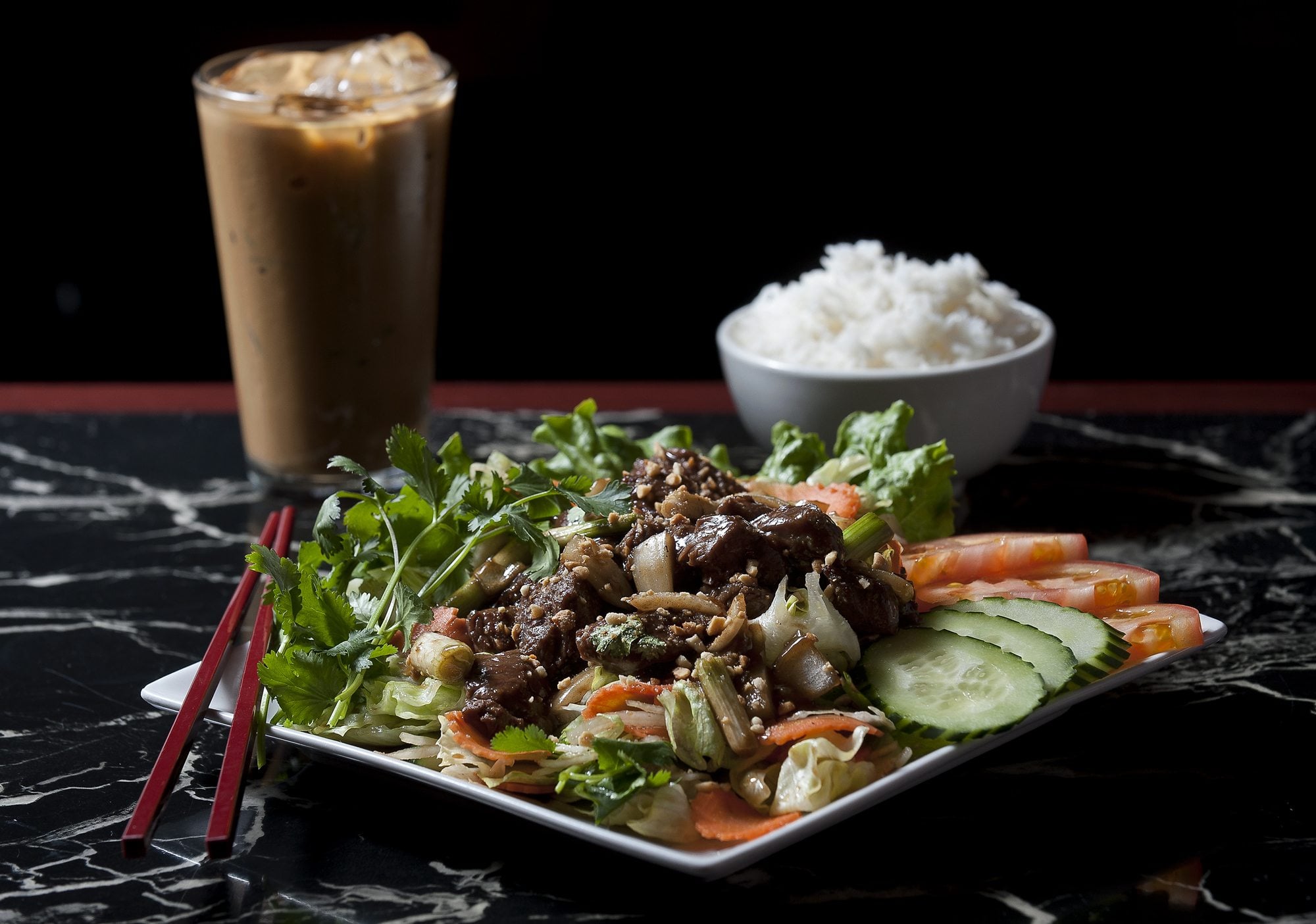 The Bo Luc Lac, a shaken beef salad, is served with steamed rice and a Vietnamese iced coffee at Tan Tan Cafe &amp; Delicatessen in Vancouver.