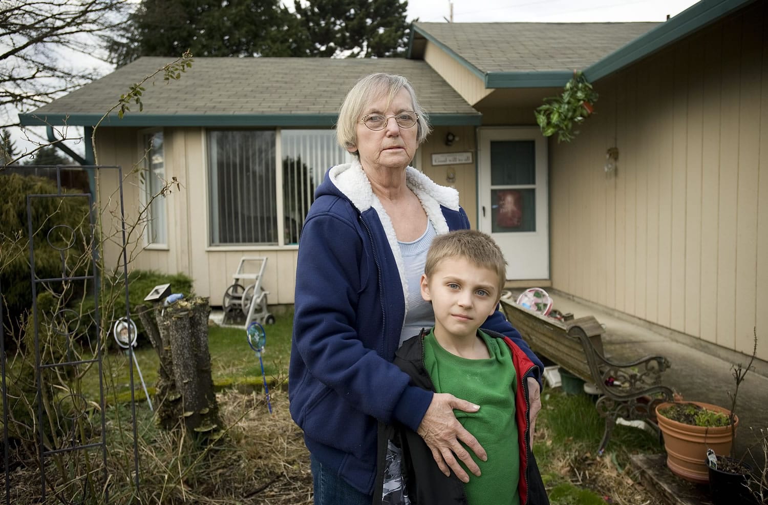 Lydia Mann of Vancouver, hugging her 6-year-old grandson, Aden Drum, fell behind on her mortgage payments and faces possible foreclosure.