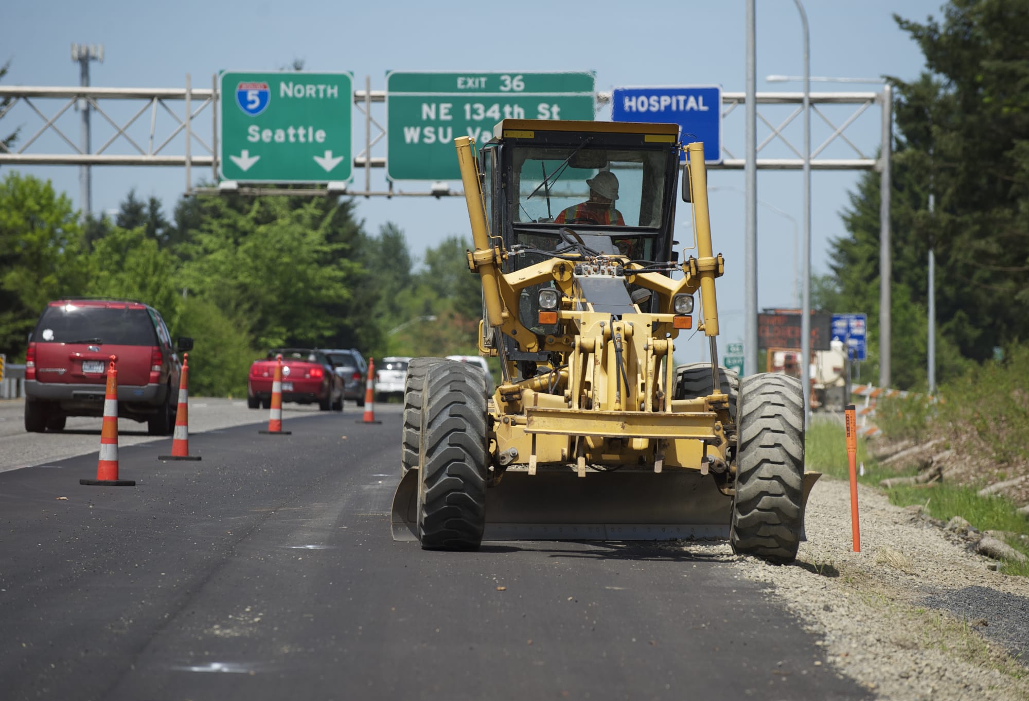 A grader driver on Monday puts the finishing touches on a new exit lane at the Northeast 134th Street exit off northbound Interstate 205. The lane is expected to open at 6 a.m.