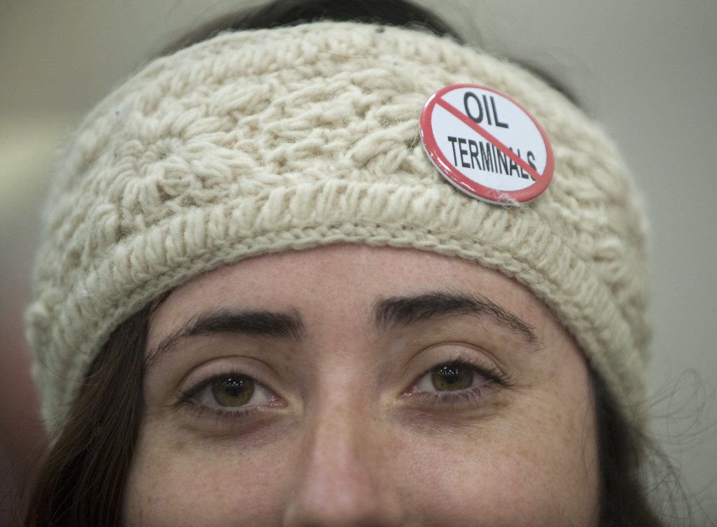 Erin Murdock wears a button indicating she is opposed to the building of an oil transfer terminal, at the first public hearing on the matter in Vancouver January 5, 2016. The state Energy Facility Site Evaluation Council, the state regulatory body that is reviewing the project, called the hearing.