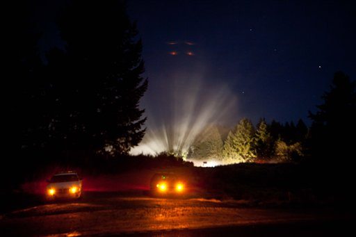 Light is visible in the background Tuesday Dec. 13, 2011, in the area where two Army Helicopters crashed Monday near Joint Base Lewis-McChord, Wash. The accident killed four soldiers, a military spokesman said late Monday.