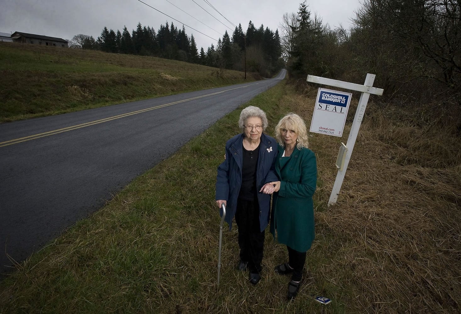 Mabel Parvi, left, poses for a portrait Friday with her friend and real estate agent Karen Lang next to 10 acres of land she owns in Ridgefield.