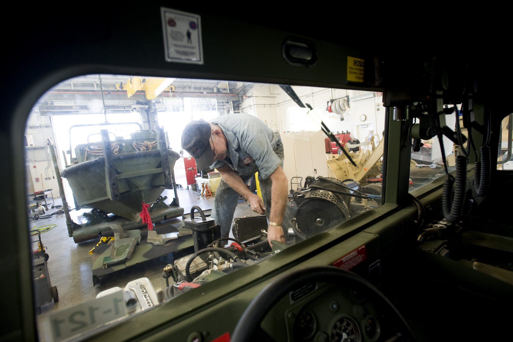 Carl Murdock changes a water pump Tuesday in a Humvee at the new Armed Forces Reserve Center in Sifton, east of Orchards.