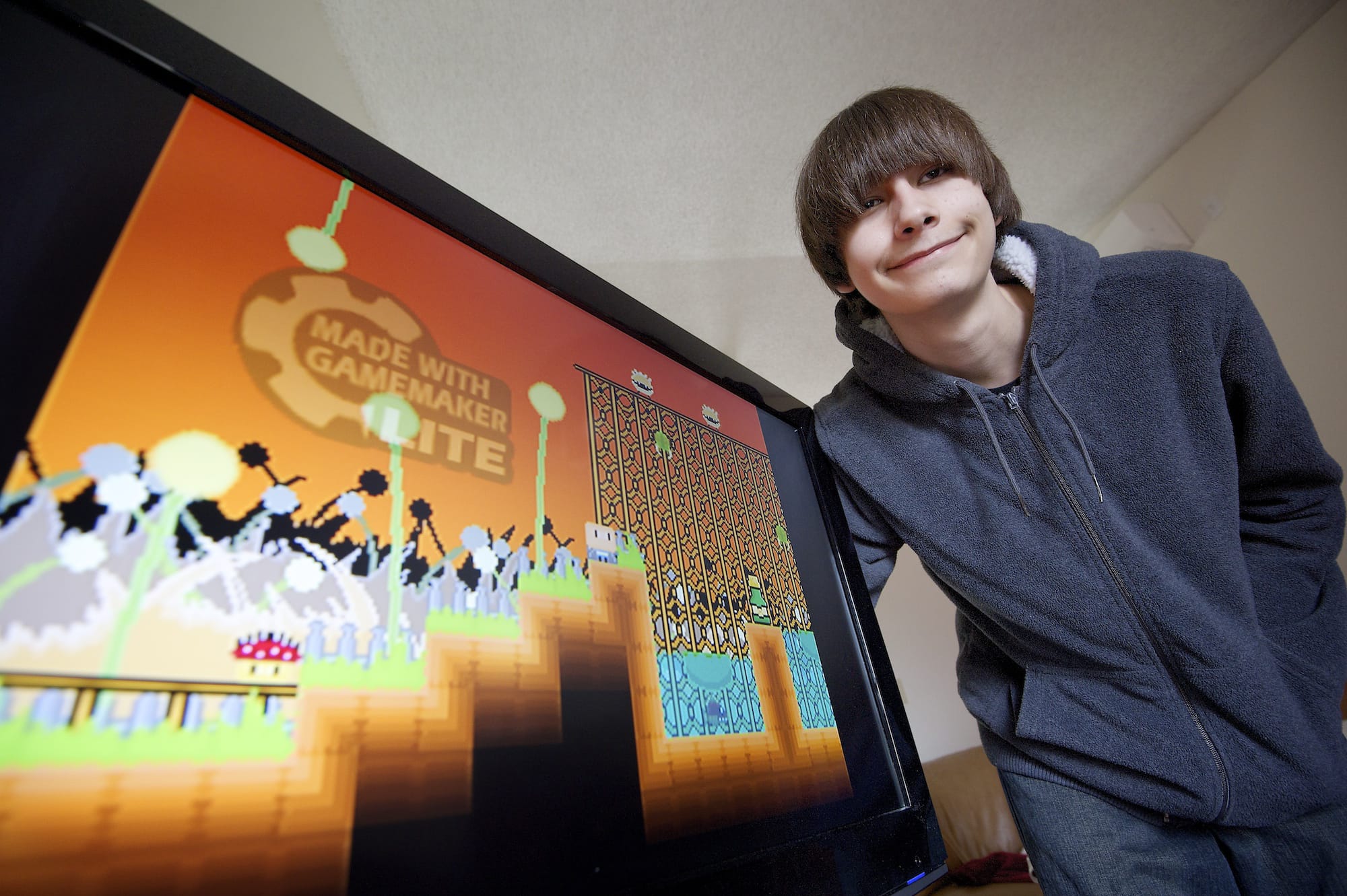 Eli Aldinger, 16, of Vancouver, shows off his video game &quot;New World.&quot; Designing the game made Aldinger a winner in the National STEM Video Game Challenge.